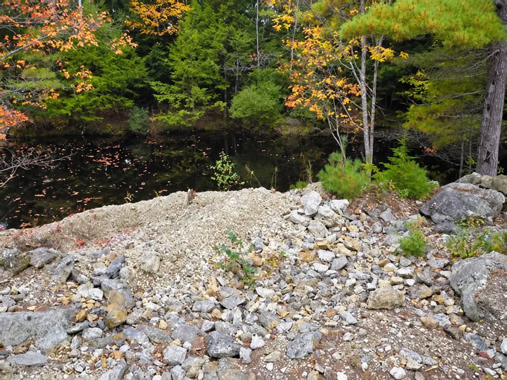 Photo showing dump site and water filled pit at Swamp Quarry #1 in Topsham, Maine